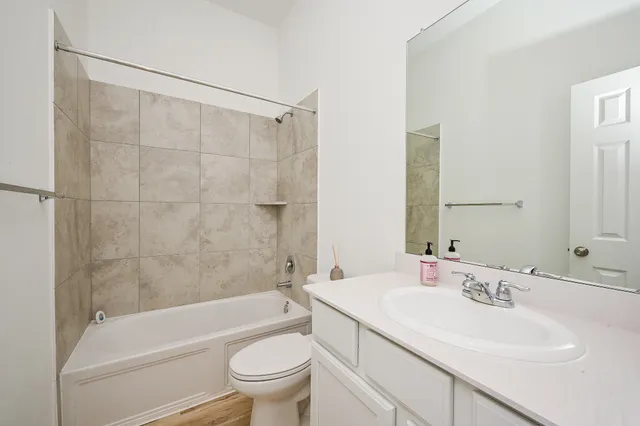 a bathroom with a sink a toilet and a bathtub