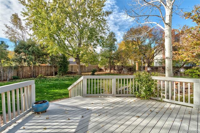 a view of a wooden deck and a yard