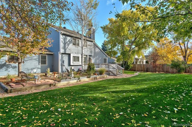 a view of a house with backyard porch and sitting area