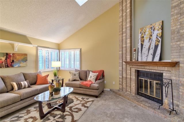 a living room with furniture a couch and a fireplace