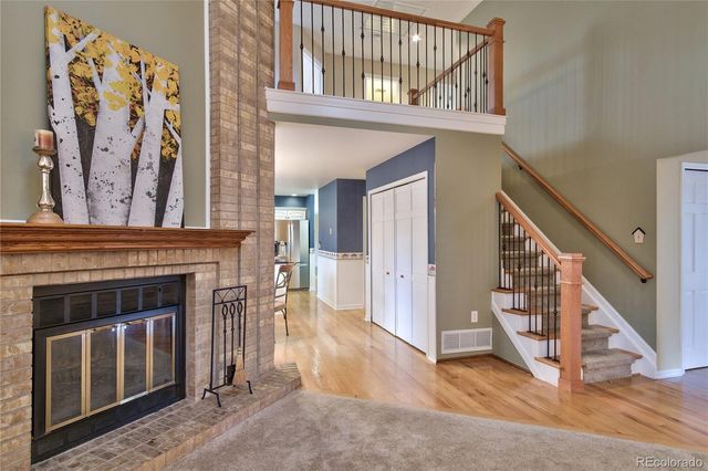 a view of a livingroom with wooden floor and stairs