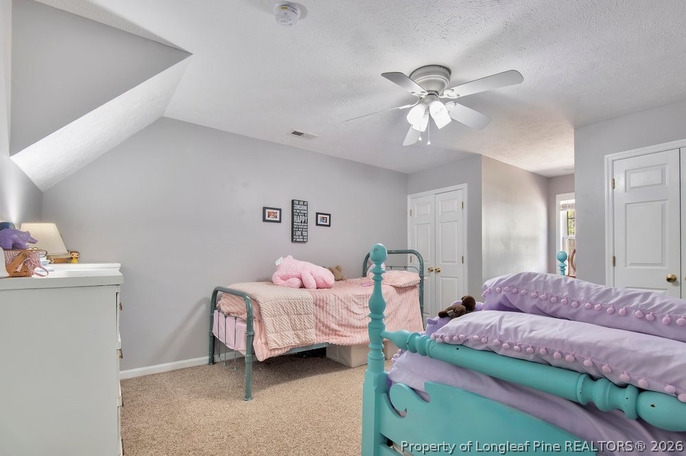 419 Senter Lane Bunnlevel, NC 28323 - Photo 31 of 49 a bedroom with bed and a chandelier