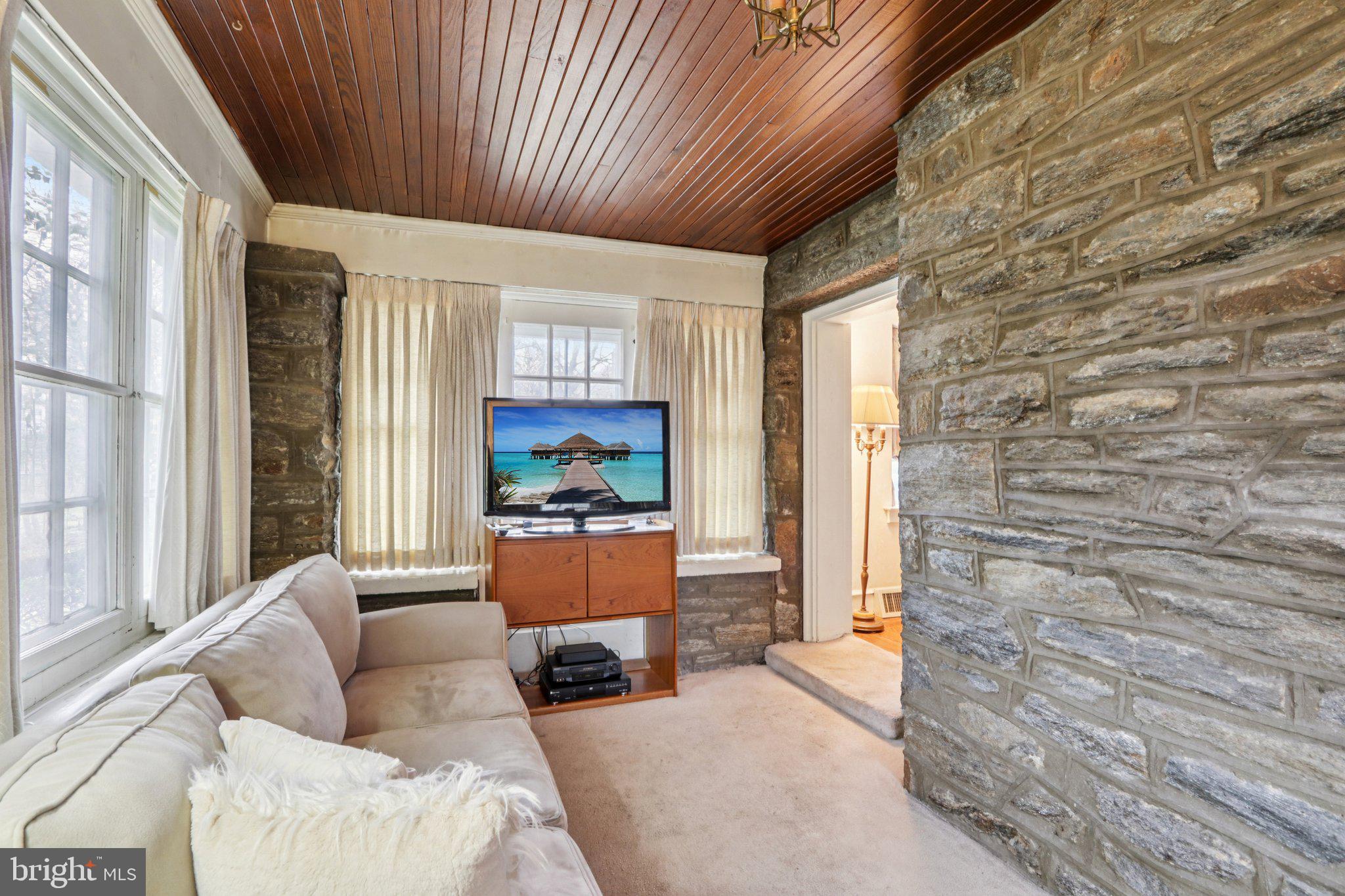 708 Meetinghouse Road Elkins Park, PA 19027 - Photo 11 of 38 a living room with furniture wooden floor and a fireplace