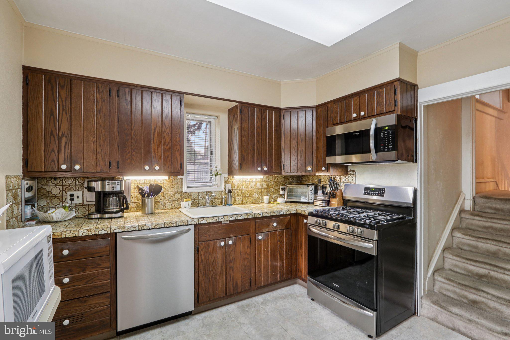 708 Meetinghouse Road Elkins Park, PA 19027 - Photo 15 of 38 a kitchen with a sink stove top oven and cabinets