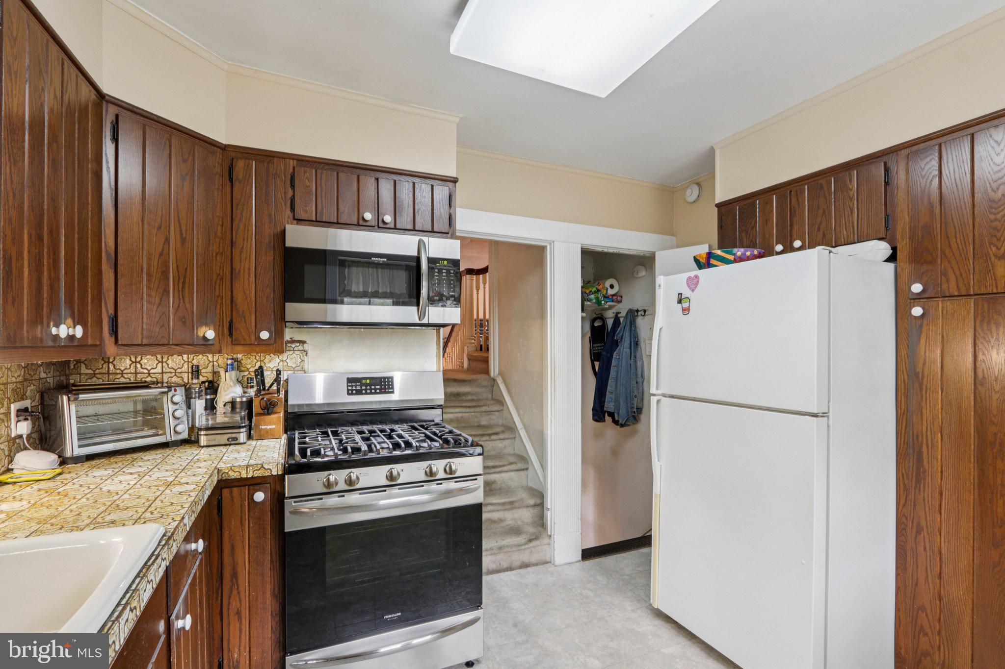 708 Meetinghouse Road Elkins Park, PA 19027 - Photo 16 of 38 a kitchen with a refrigerator stove and microwave