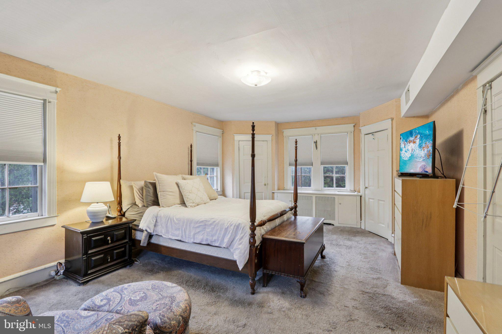 708 Meetinghouse Road Elkins Park, PA 19027 - Photo 18 of 38 a spacious bedroom with a bed a couch and large window