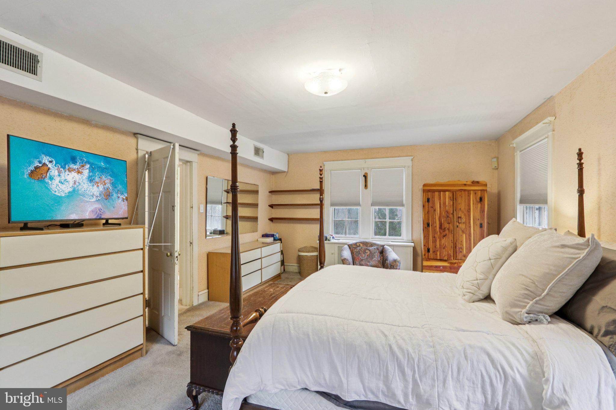 708 Meetinghouse Road Elkins Park, PA 19027 - Photo 19 of 38 a bedroom with a balcony a bed and a flat screen tv