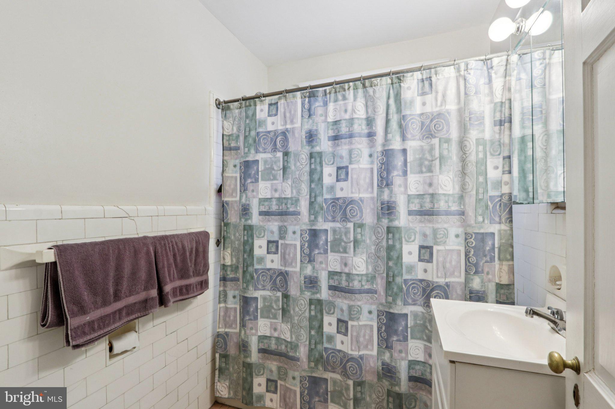 708 Meetinghouse Road Elkins Park, PA 19027 - Photo 25 of 38 a bathroom with a shower curtain and a sink