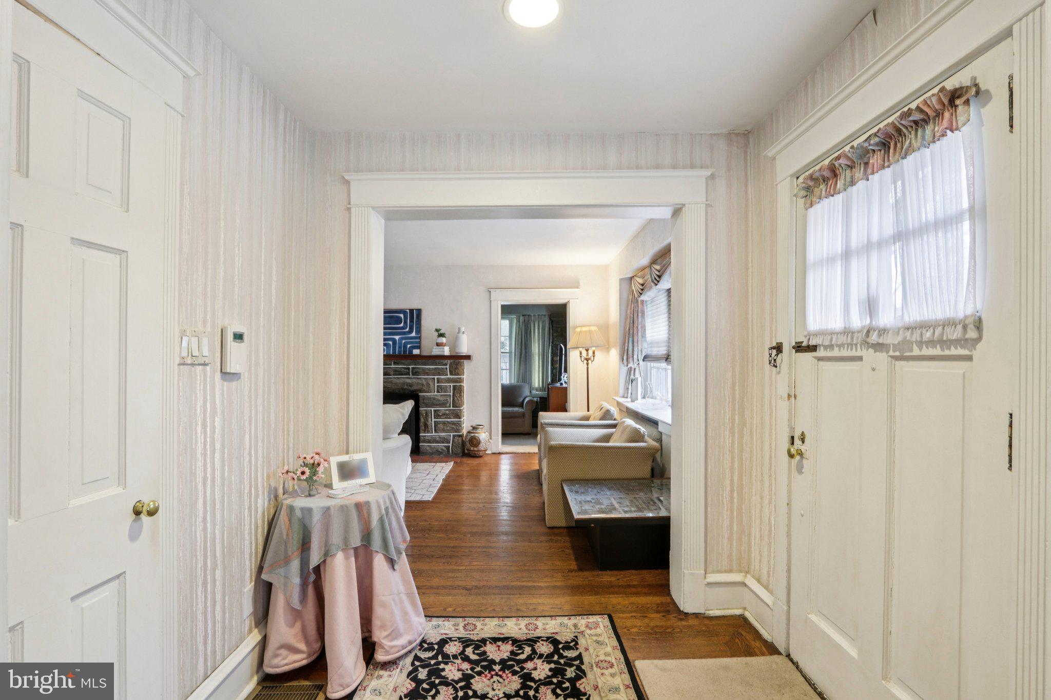 708 Meetinghouse Road Elkins Park, PA 19027 - Photo 4 of 38 a hallway with a dining table and a rug