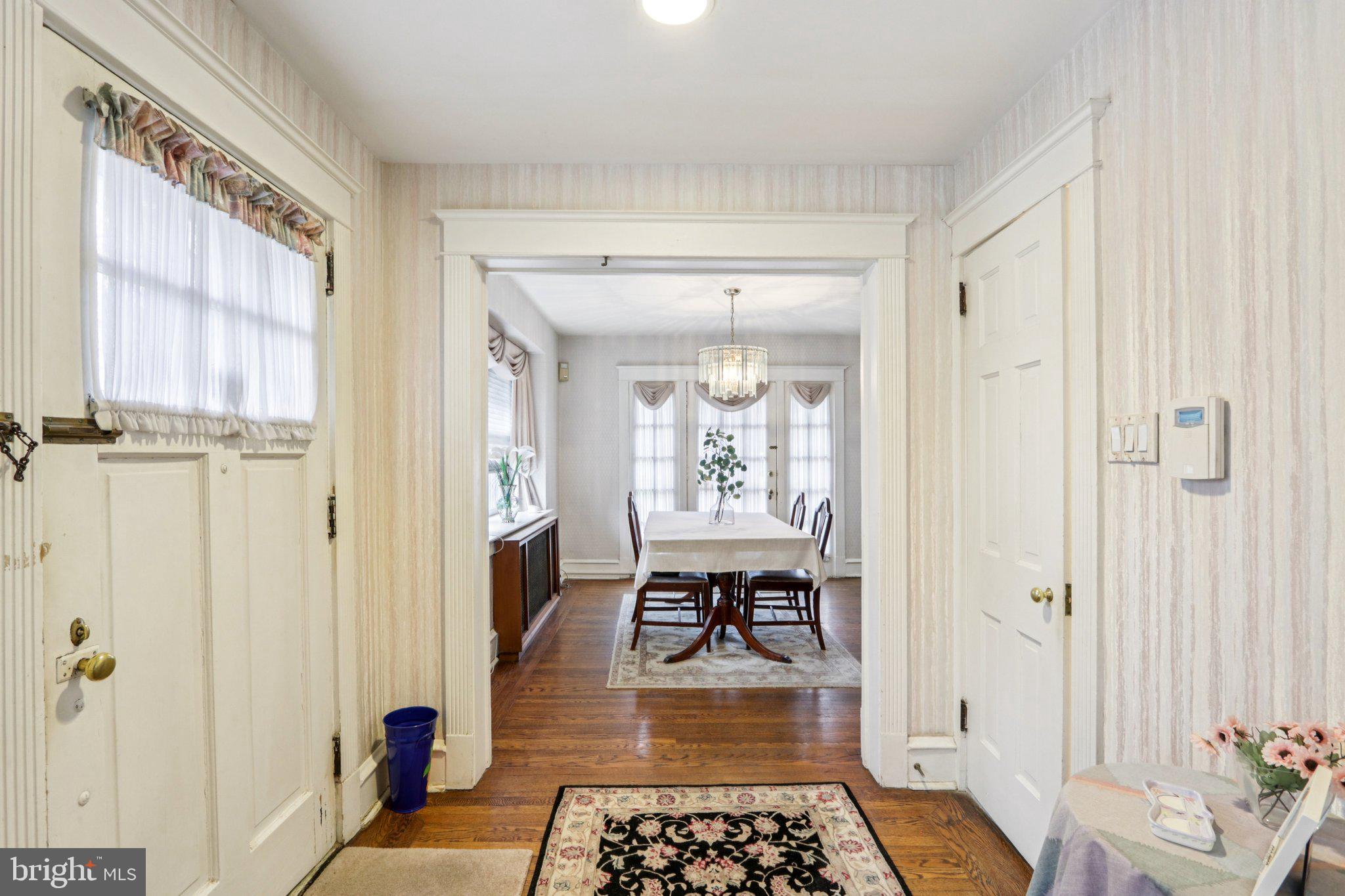 708 Meetinghouse Road Elkins Park, PA 19027 - Photo 5 of 38 a hallway with a dining table and chairs