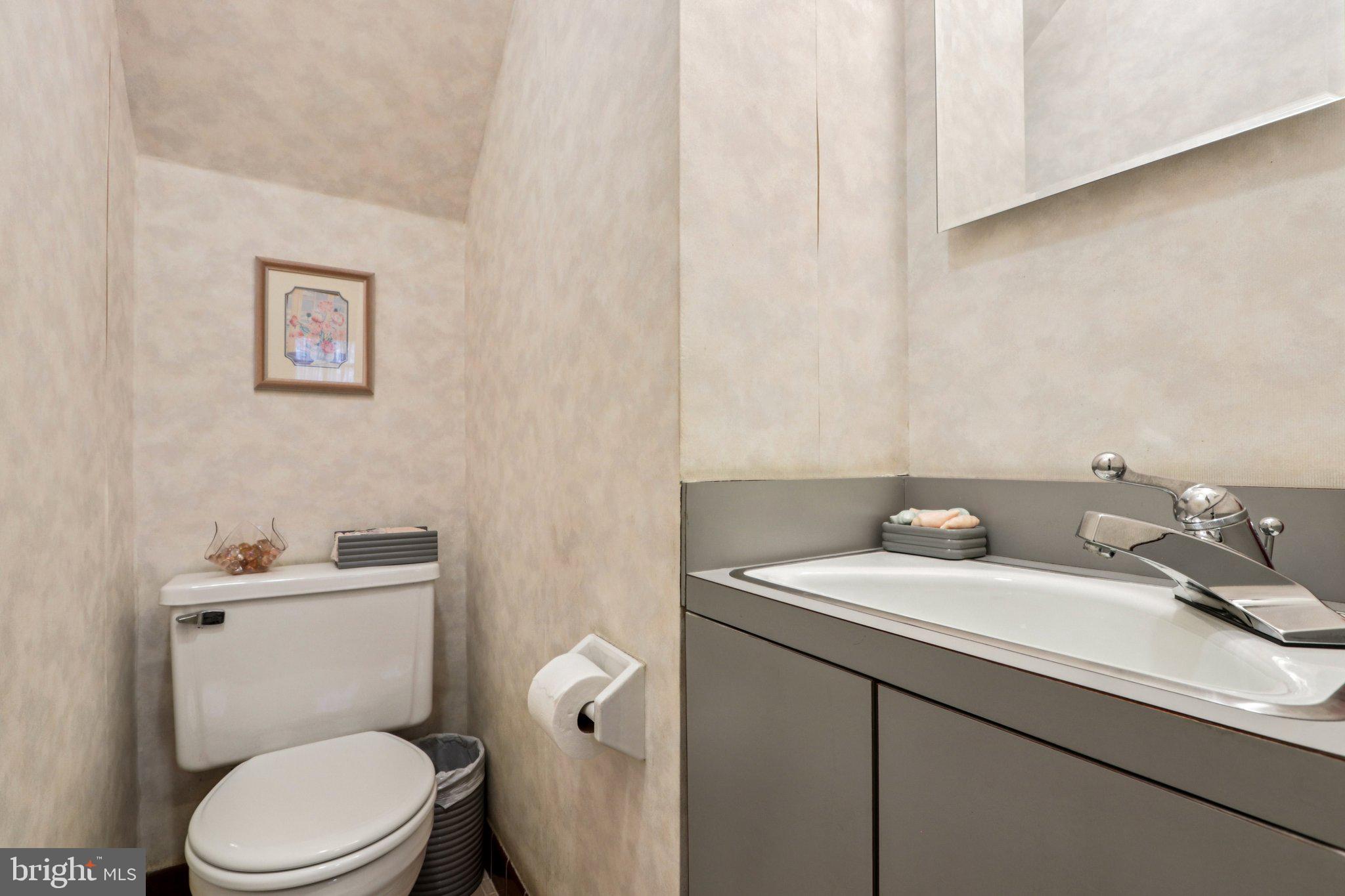 708 Meetinghouse Road Elkins Park, PA 19027 - Photo 7 of 38 a bathroom with a sink a toilet and a mirror