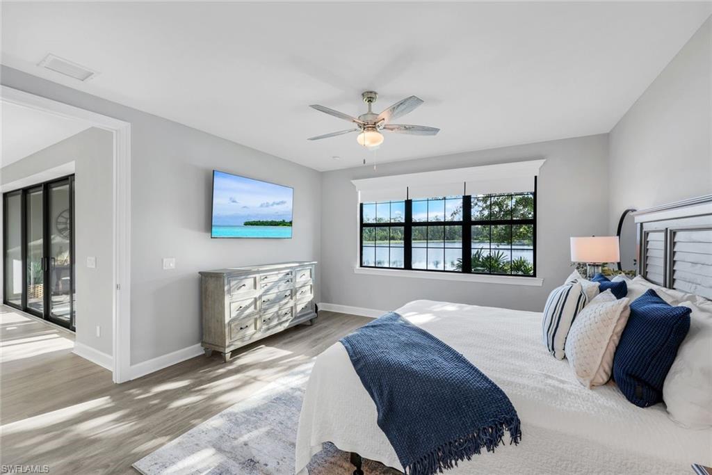 9641 Montelanico Loop, Unit 103 Naples, FL 34119 - Photo 12 of 28 a bedroom with a bed and a couch