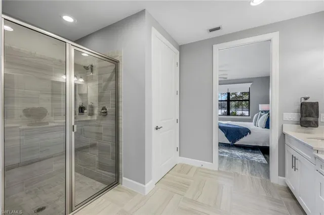 a bathroom with a tub shower and sink