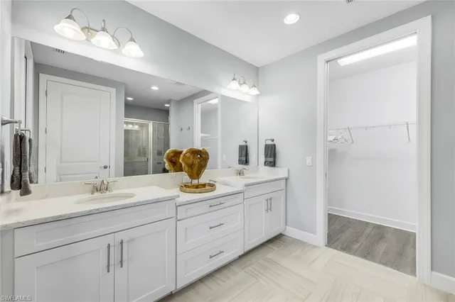 a bathroom with a sink double vanity and a mirror