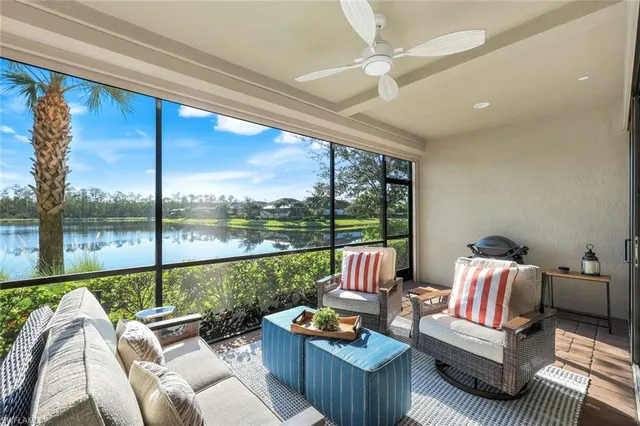 a living room with furniture and a floor to ceiling window