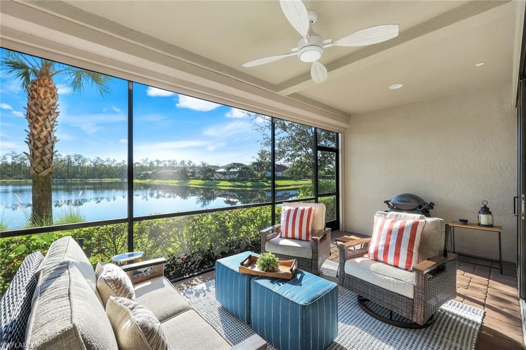 9641 Montelanico Loop, Unit 103 Naples, FL 34119 - Photo 19 of 28 a living room with furniture and a floor to ceiling window