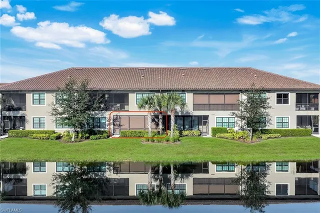 a view of a house with garden space and a car park in front of it