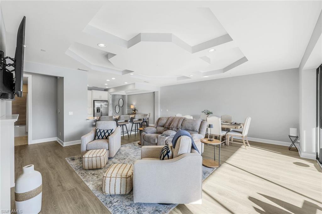 9641 Montelanico Loop, Unit 103 Naples, FL 34119 - Photo 3 of 28 a living room with furniture and a table