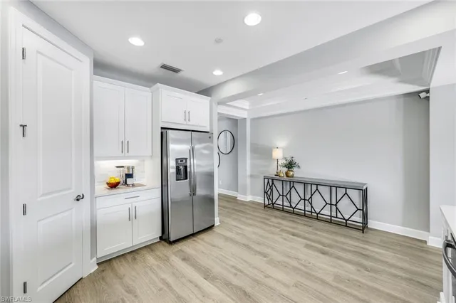 a view of kitchen with furniture and refrigerator