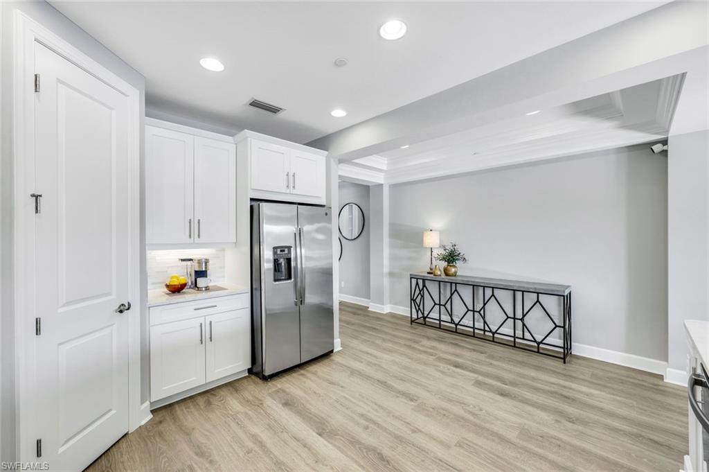 9641 Montelanico Loop, Unit 103 Naples, FL 34119 - Photo 9 of 28 a view of kitchen with furniture and refrigerator
