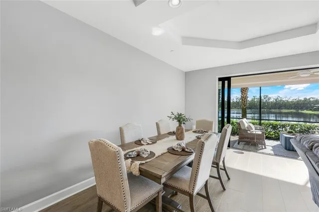 a dining room with furniture and a floor to ceiling window