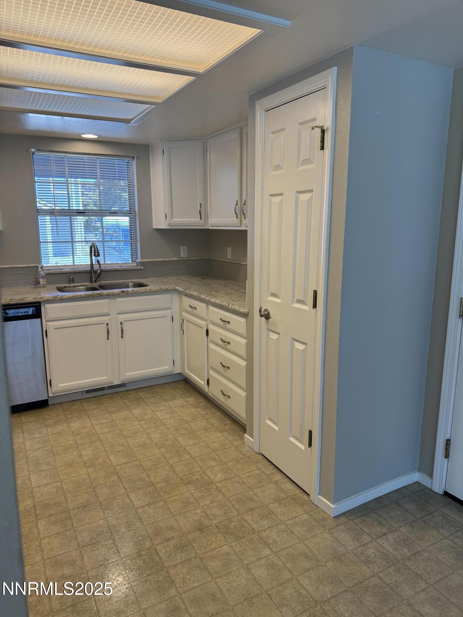 3016 Hauser Court Carson City, NV 89701 - Photo 10 of 13 a kitchen with granite countertop white cabinets and white appliances