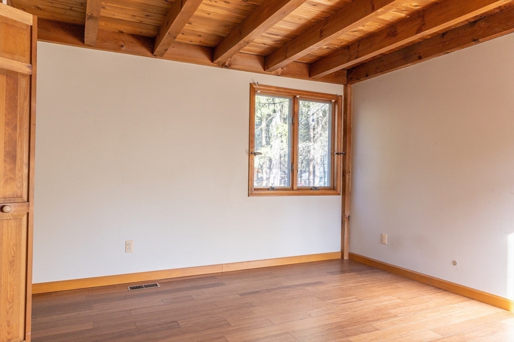 526 Station Road Amherst, MA 01002 - Photo 23 of 42 a view of an empty room with wooden floor and a window