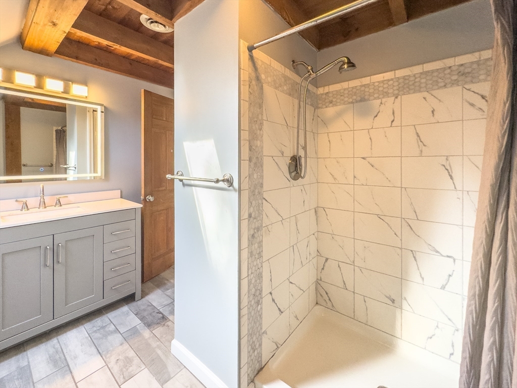 526 Station Road Amherst, MA 01002 - Photo 35 of 42 a bathroom with a double vanity sink a mirror and shower