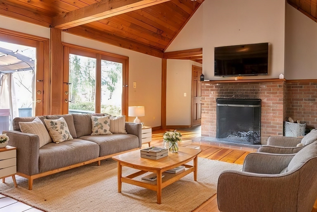 526 Station Road Amherst, MA 01002 - Photo 5 of 42 a living room with furniture a flat screen tv and a fireplace