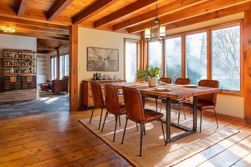 526 Station Road Amherst, MA 01002 - Photo 6 of 42 a view of a dining room with furniture large windows and wooden floor
