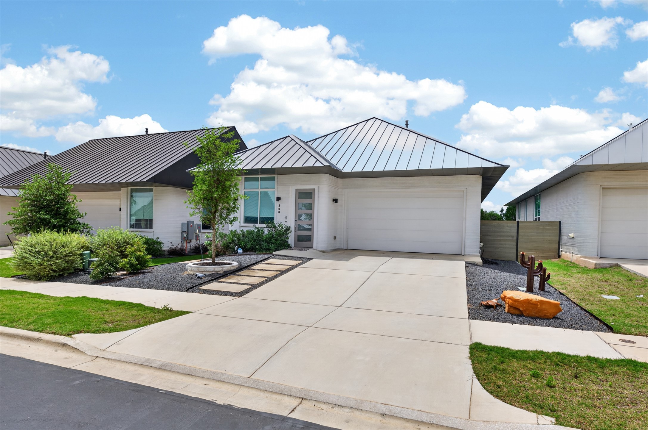 308 Painted Sunset Drive Georgetown, TX 78628 - Photo 2 of 26 Contemporary single-story residence featuring a metal roof, white exterior, and an attached garage