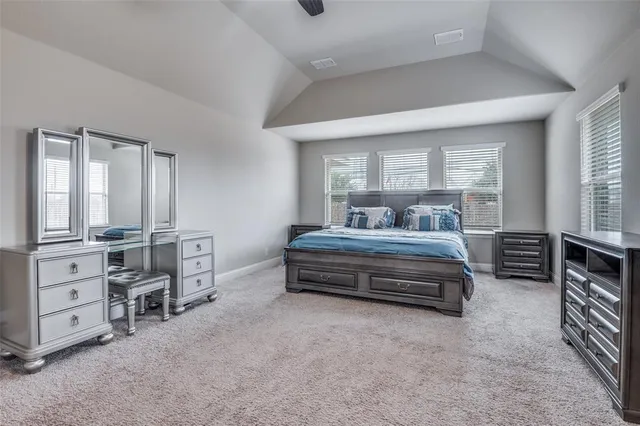a bedroom with furniture and a large window