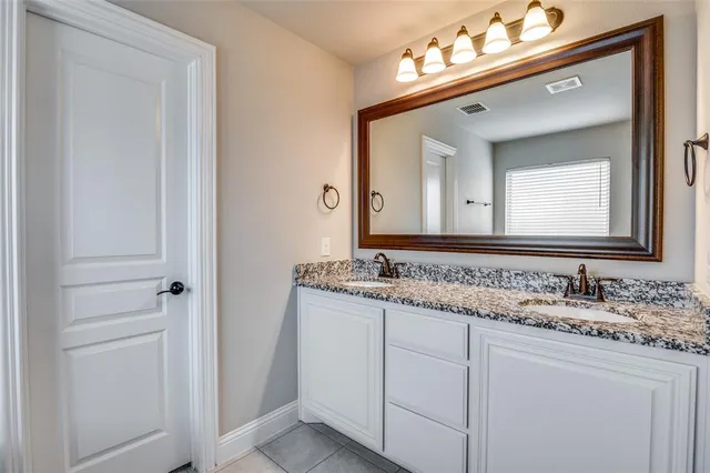 a bathroom with a sink vanity and a mirror