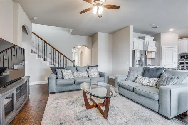 a living room with furniture and a dining table