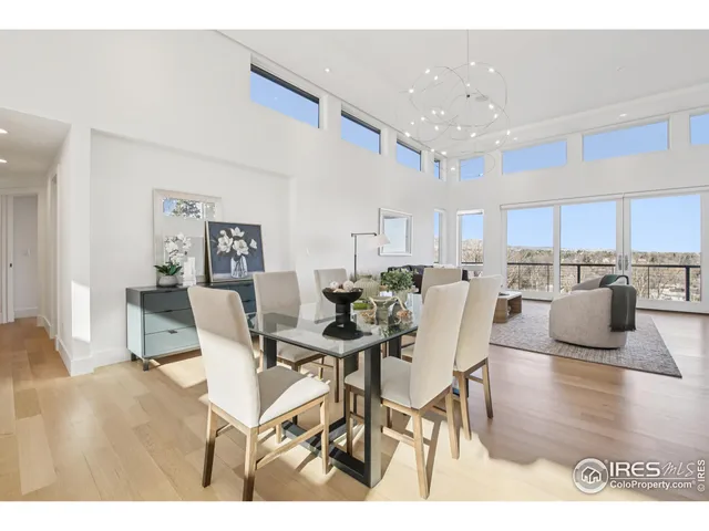 a living room with lots of furniture and kitchen view