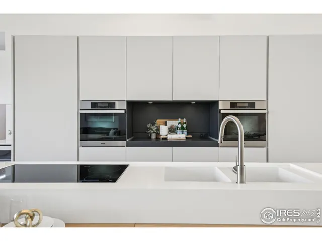 a kitchen with a sink and white cabinets