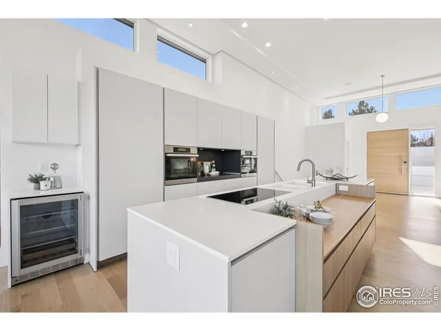 a kitchen with stainless steel appliances granite countertop a sink a stove and a refrigerator