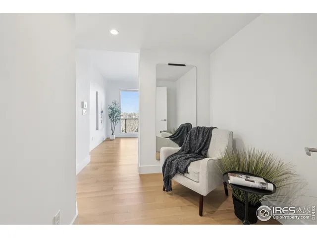 a view of living room filled with furniture and wooden floor