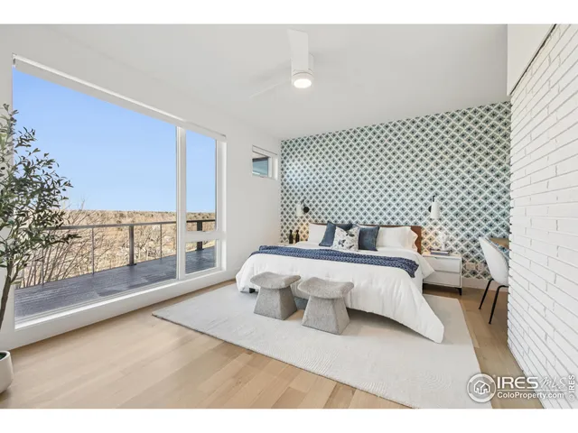 a bedroom with a bed and a large window