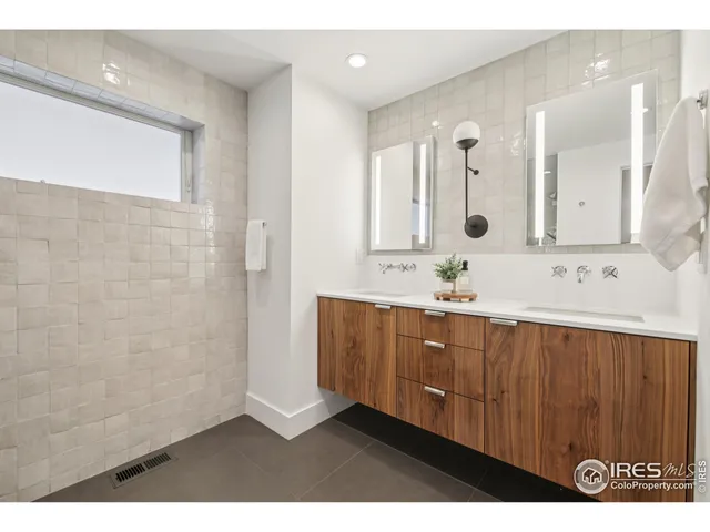 a bathroom with a sink a mirror and a shower