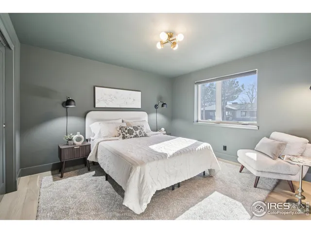 a bedroom with a bed and a painting on the wall