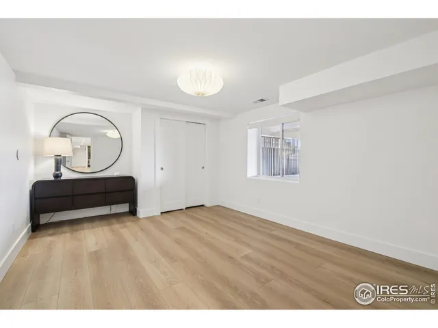 a view of a room with wooden floor and glass windows