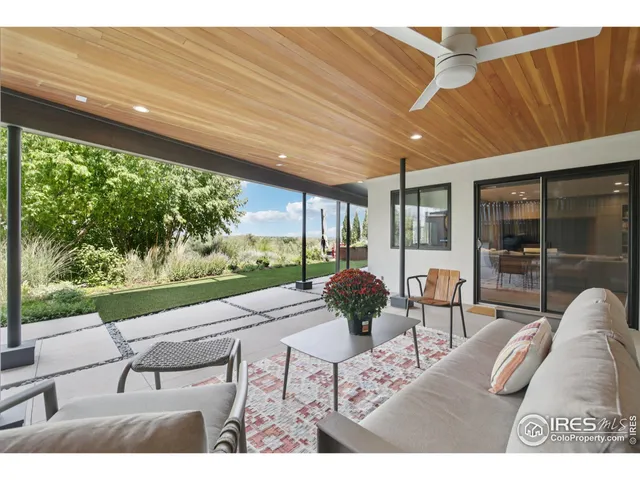 a building outdoor space with patio furniture and garden