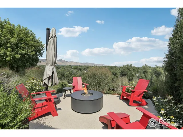 a roof deck with couch and outdoor seating