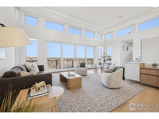 a living room with furniture and a view of kitchen