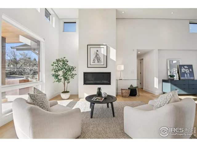 a living room with furniture a large window and a flat screen tv