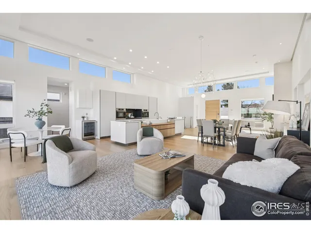 a living room with furniture and view of kitchen