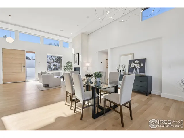 a dining room with furniture and wooden floor
