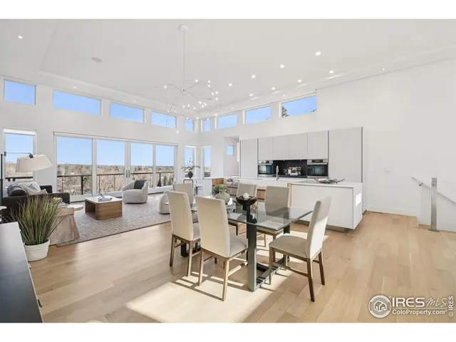 a living room with lots of furniture and kitchen view