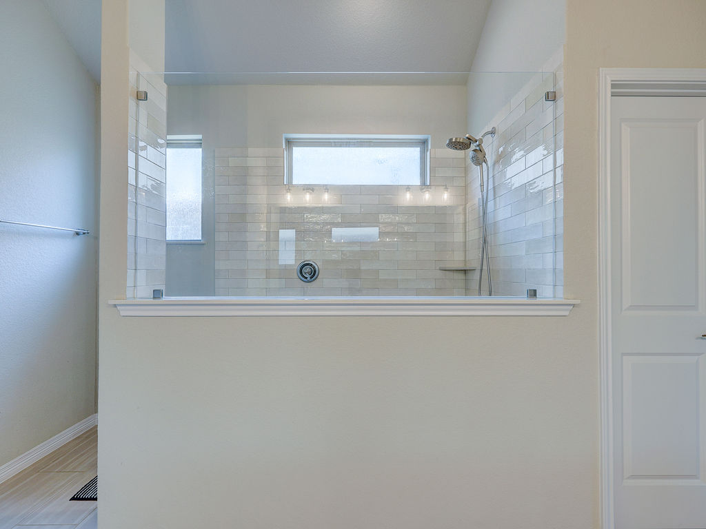 229 Heartleaf Road San Marcos, TX 78666 - Photo 30 of 40 A well-appointed shower area offers privacy and natural light.
